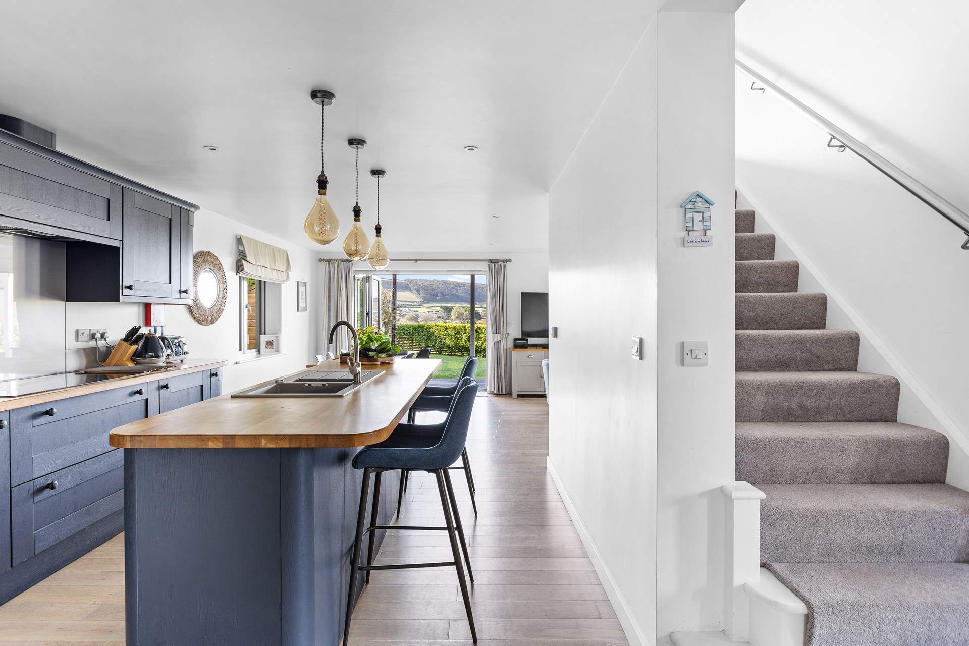 Head upstairs to find three of the four bedrooms with the bunk bed room being to the right of the stairs.