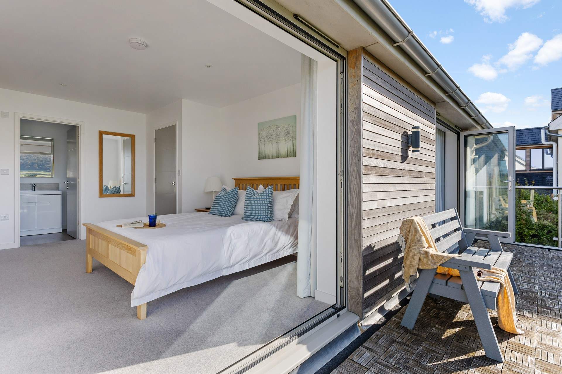 The balcony is shared by the two king bedrooms that sit to the front of the house with costal views.