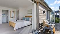The balcony is shared by bedrooms 2 and 3 that sit to the front of the house with coastal views.