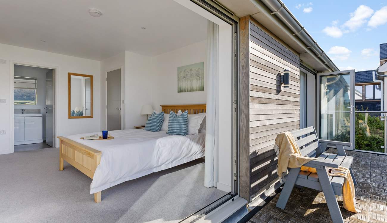 The balcony is shared by bedrooms 2 and 3 that sit to the front of the house with coastal views.