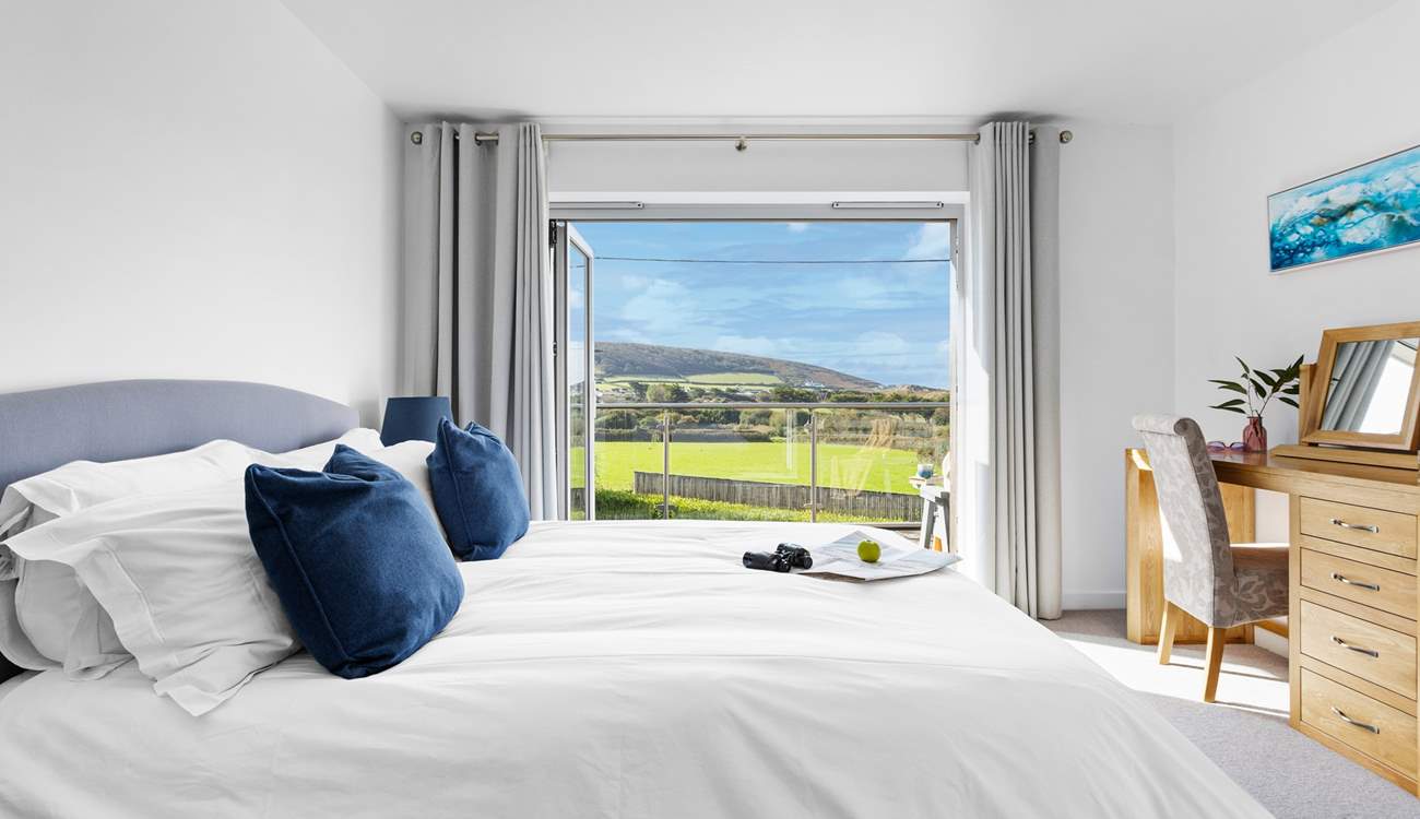 The picture window with views towards the beach and sand dunes.