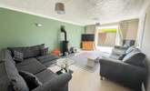 The sitting-room has cosy seating and a warming wood-burner for cooler days.  - Thumbnail Image