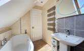 The family bathroom has a bath for a long soak after a busy beach day.  - Thumbnail Image