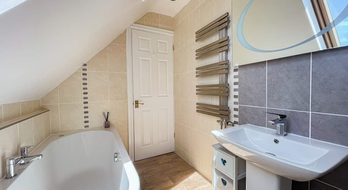 The family bathroom has a bath for a long soak after a busy beach day. 