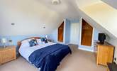 Spacious bedroom 1 has a king-size bed and a TV. - Thumbnail Image