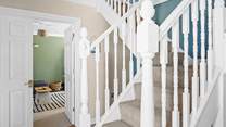 Climb the stairs to the bedrooms on the first floor. 