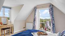 The double bedroom has a balcony, perfect for your morning coffee with a view. 