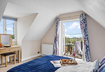 The double bedroom has a balcony, perfect for your morning coffee with a view. 