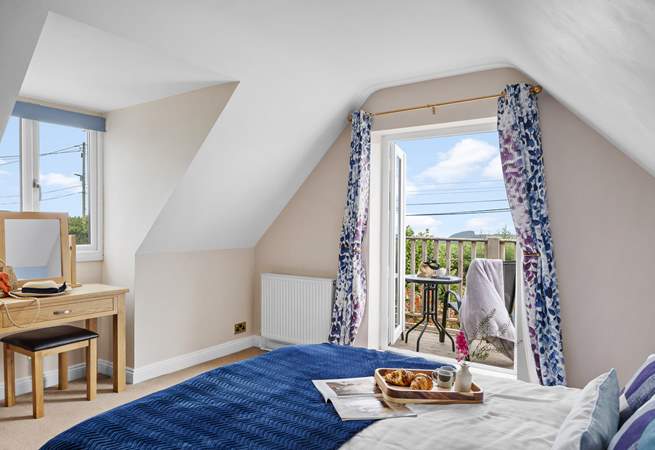 The double bedroom has a balcony, perfect for your morning coffee with a view. 