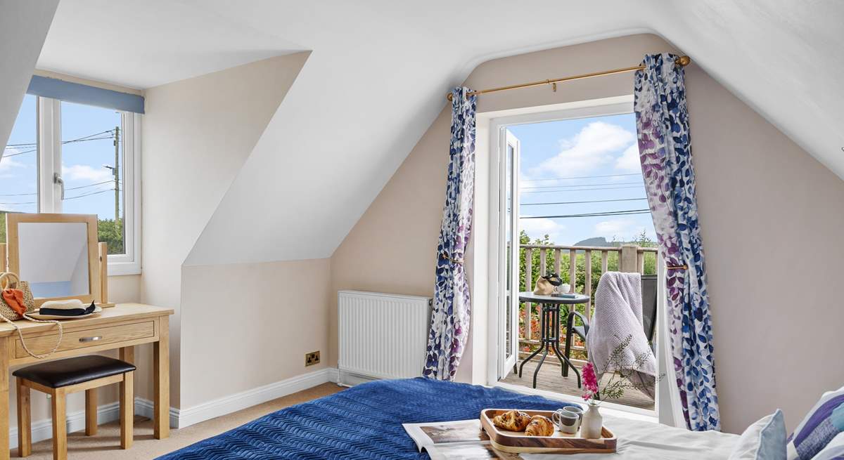 The double bedroom has a balcony, perfect for your morning coffee with a view. 
