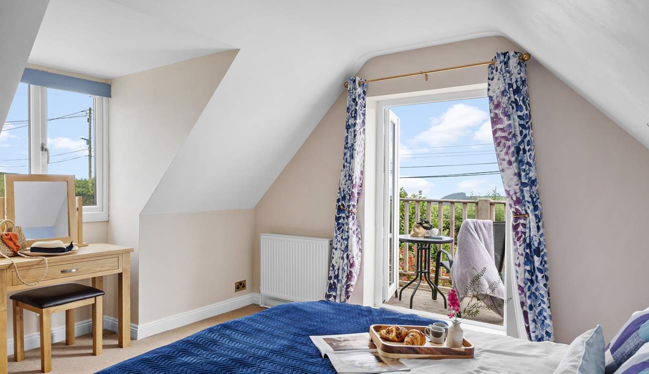 The double bedroom has a balcony, perfect for your morning coffee with a view. 