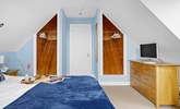 Spacious bedroom 1 has a king-size bed and a TV. - Thumbnail Image