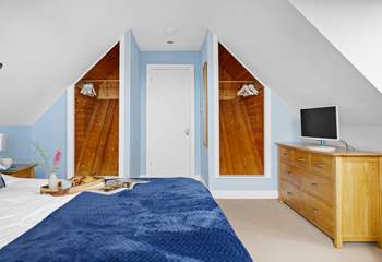 Spacious bedroom 1 has a king-size bed and a TV.