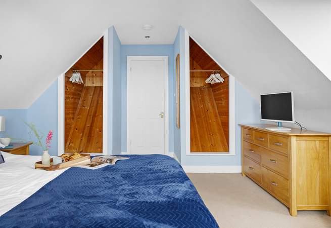 Spacious bedroom 1 has a king-size bed and a TV.