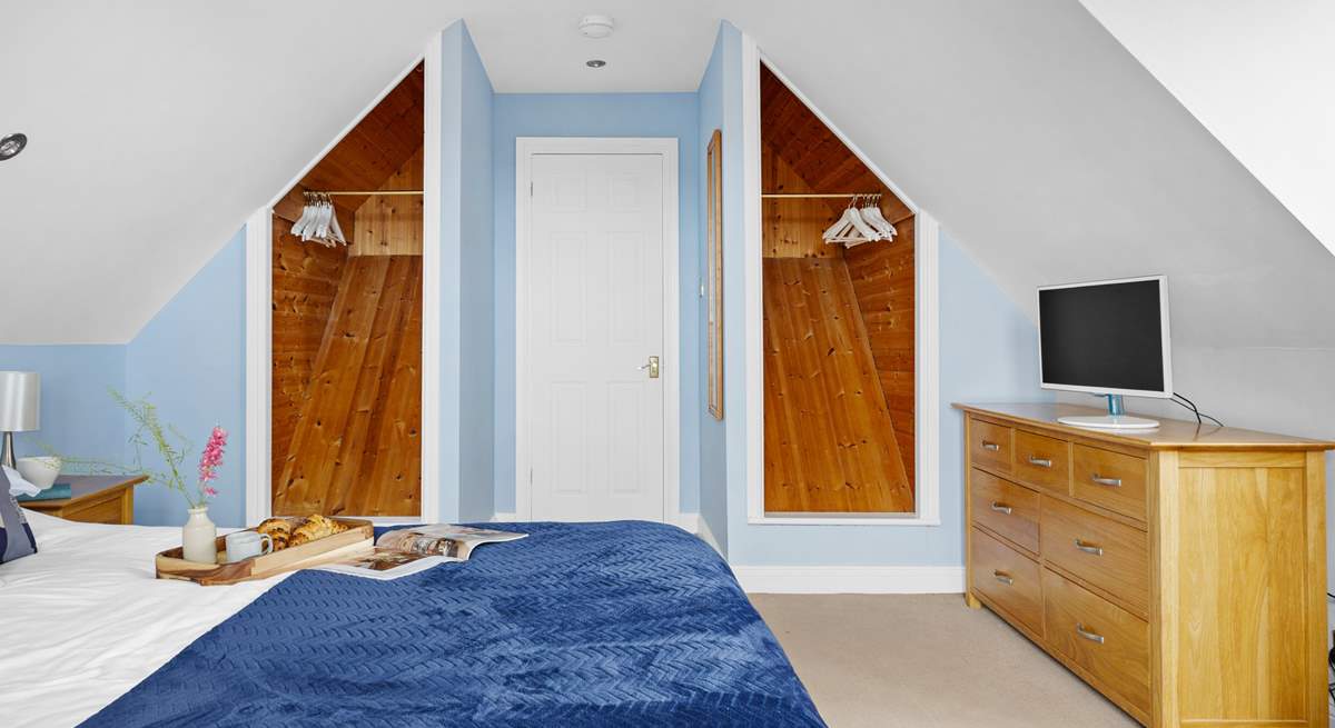 Spacious bedroom 1 has a king-size bed and a TV.
