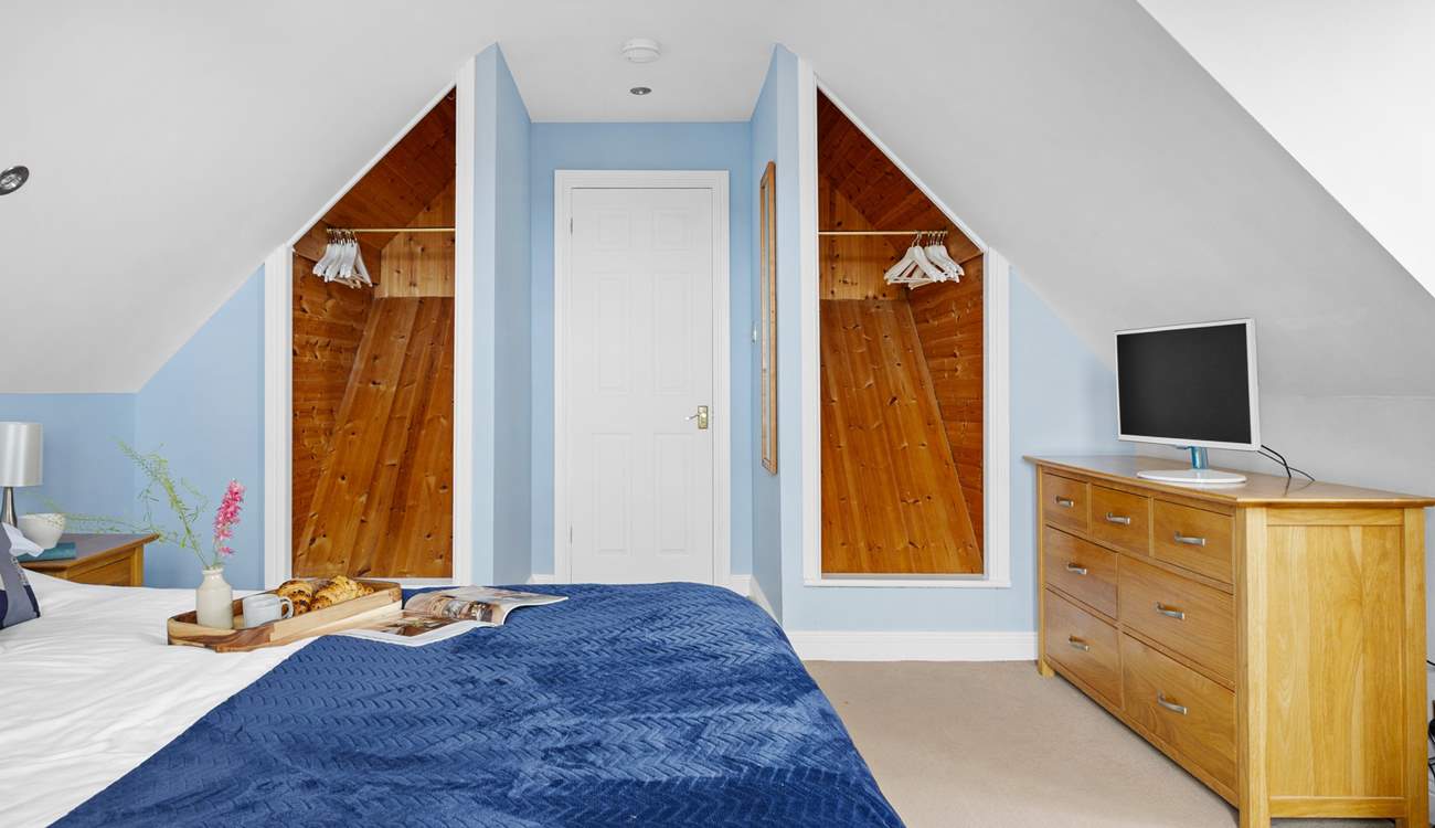 Spacious bedroom 1 has a king-size bed and a TV.