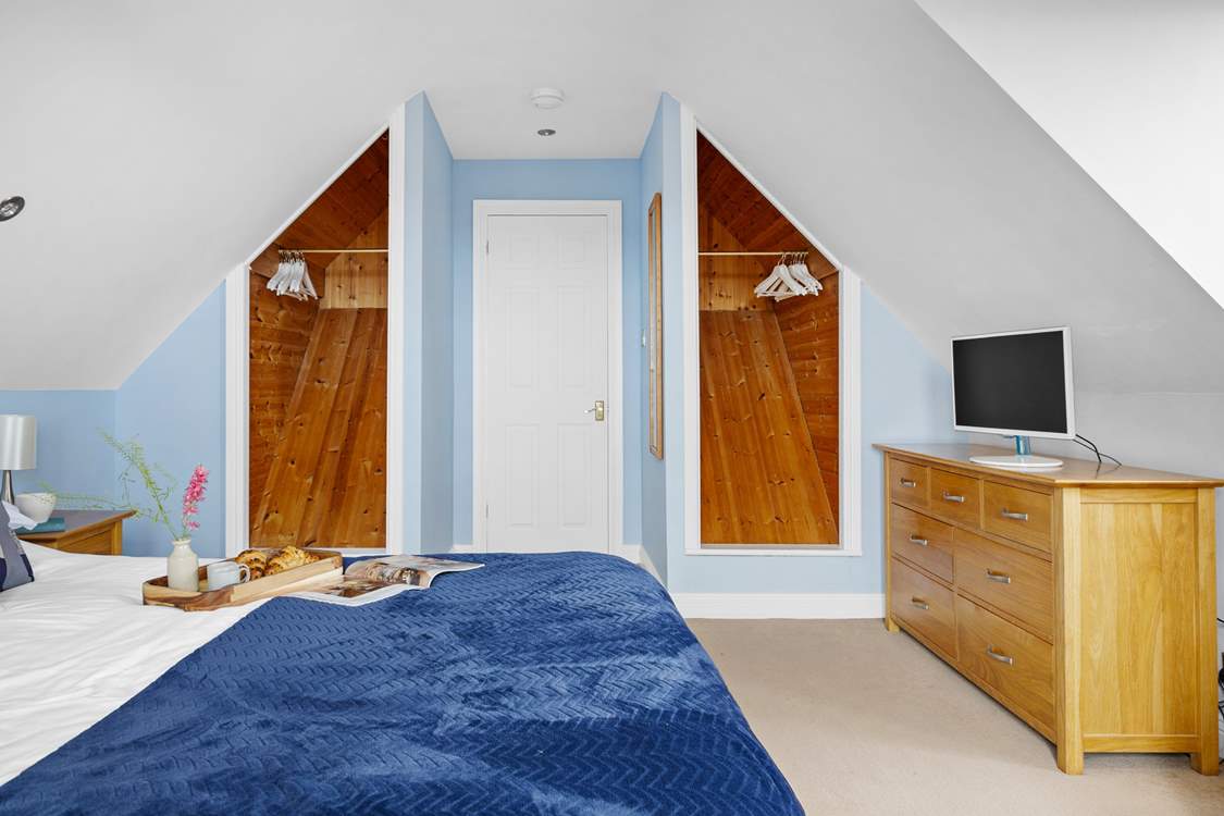 Spacious bedroom 1 has a king-size bed and a TV.