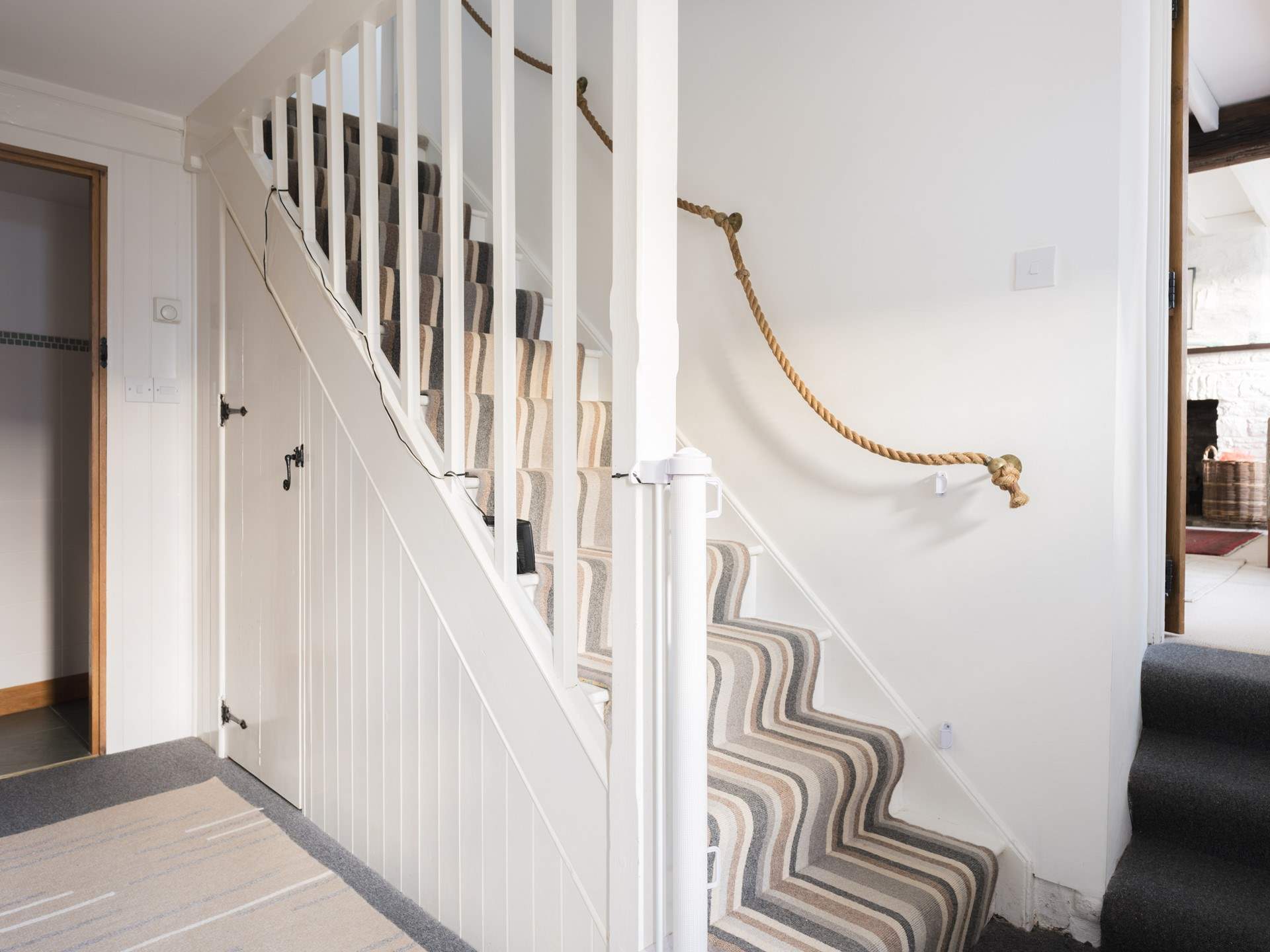 Head back to the downstairs hall and head upstairs to find all the bedrooms. To the left you can see the door opening onto the downstairs WC.