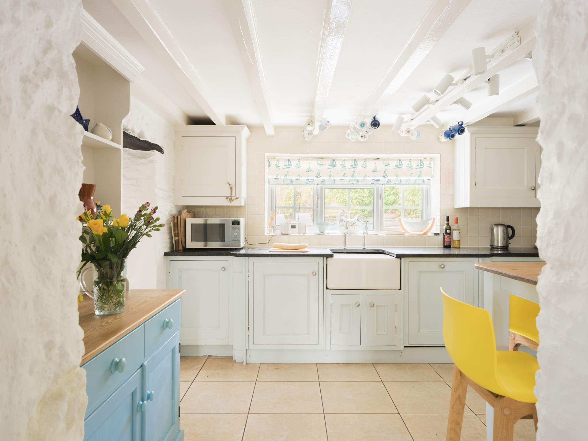 The kitchen looks out on  to the rear garden patio area.