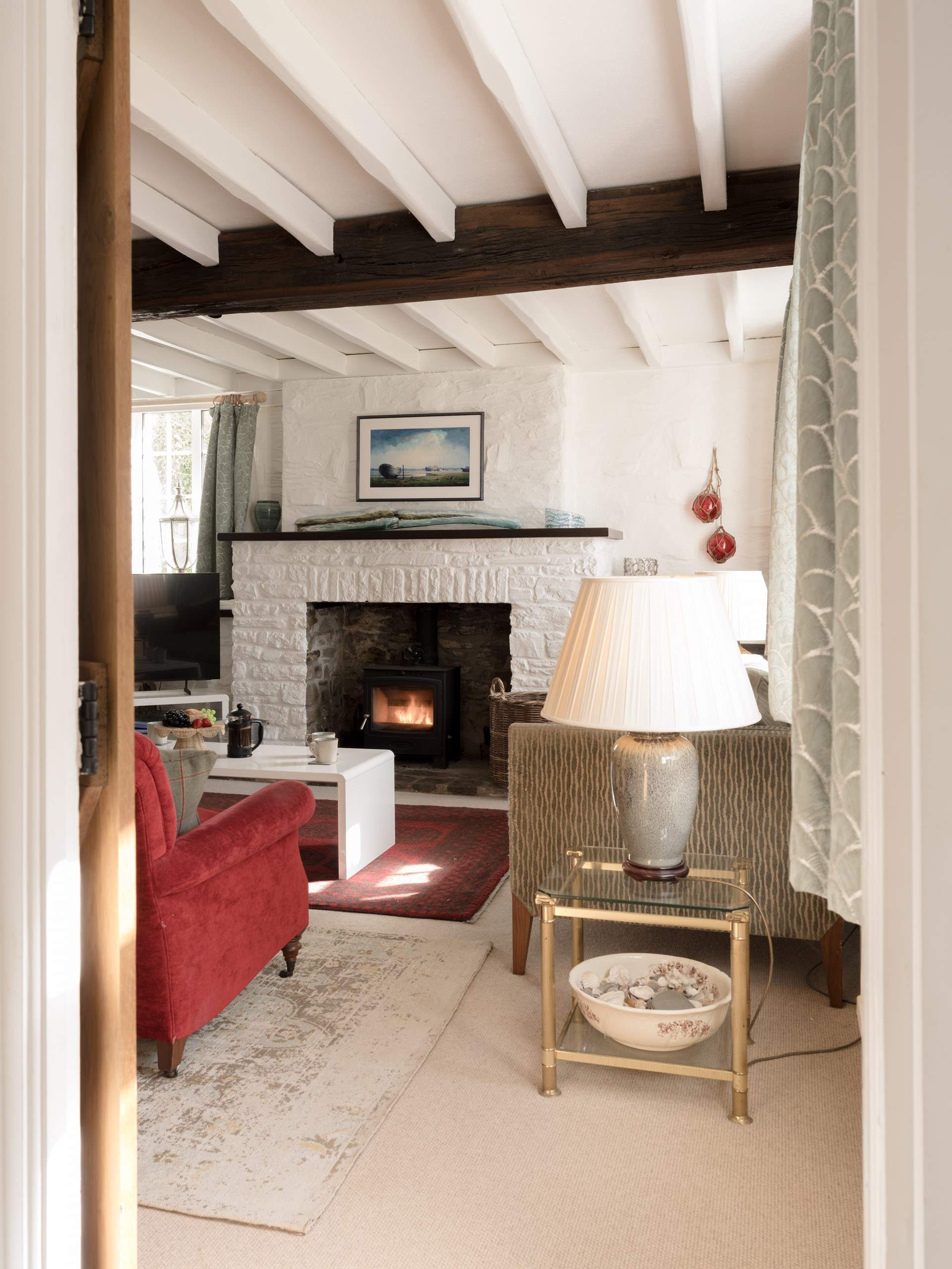Head across to the sitting room passing the downstairs WC and staircase up to the first floor.