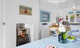 The fire warms both the sitting and dining areas.  - Thumbnail Image