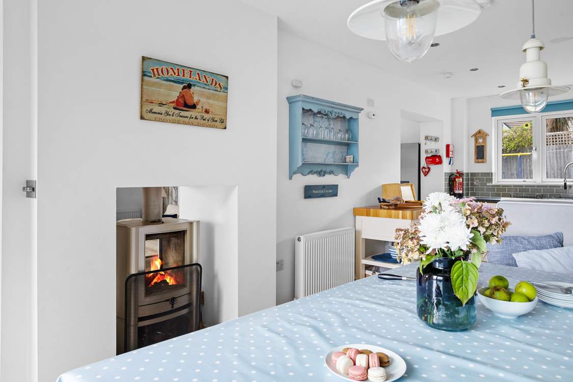 The fire warms both the sitting and dining areas.