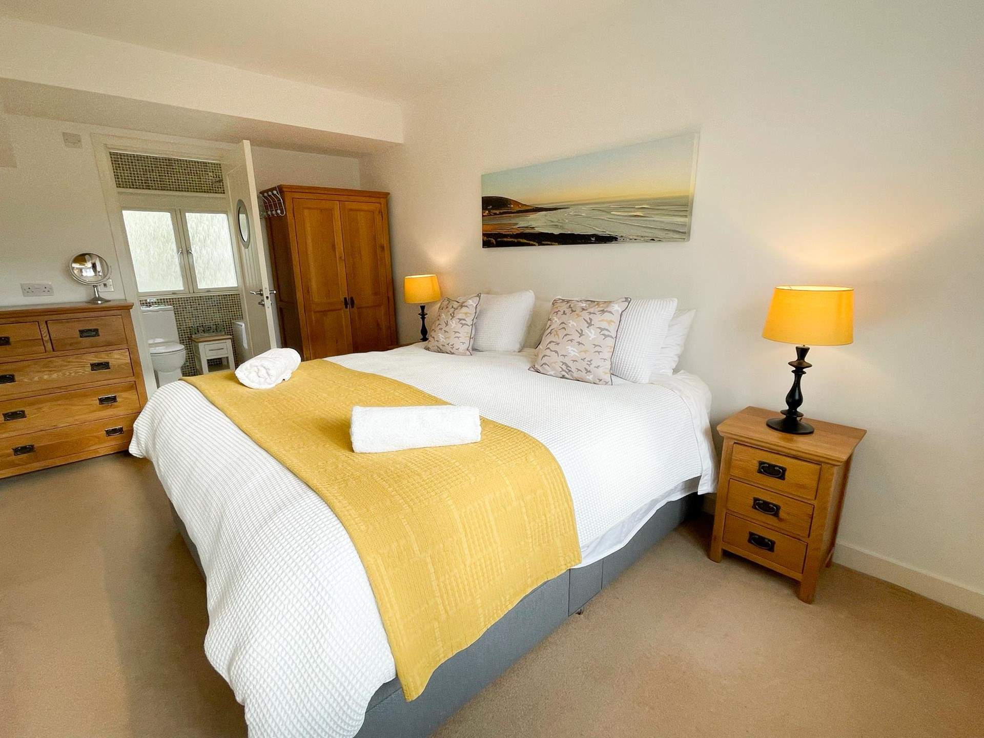 Bedroom 1 has an en suite bathroom and views across the rooftops to the coast.