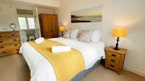 Bedroom 1 has an en suite bathroom and views across the rooftops to the coast.
