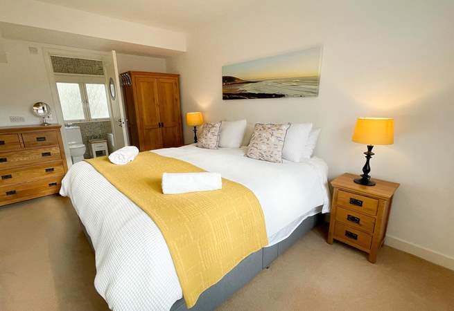 Bedroom one with ensuite and views across the rooftops to the coast.