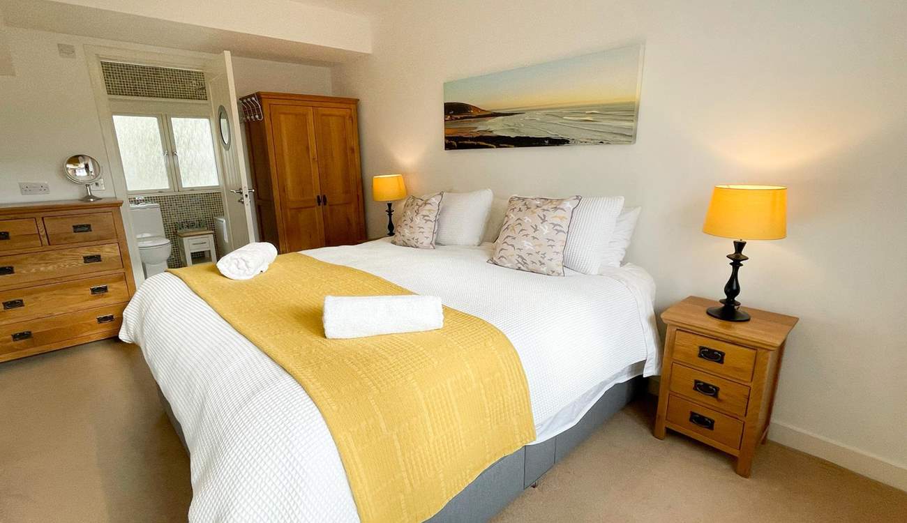 Bedroom 1 has an en suite bathroom and views across the rooftops to the coast.