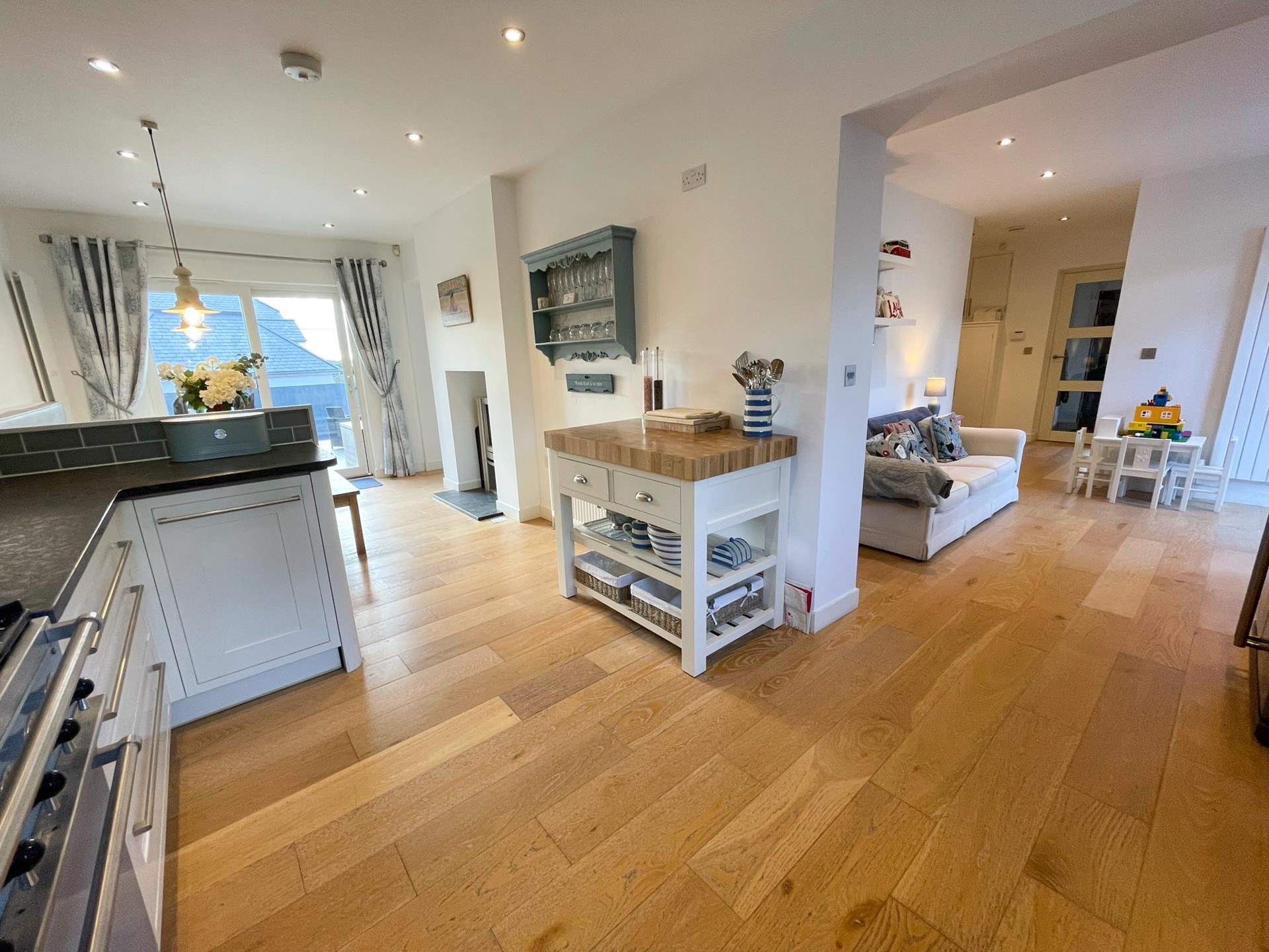 Just off of the kitchen you will find the perfect sofa to enjoy a morning coffee whilst the children play. You can even open the patio door on to an enclosed area where the children and dog can play.