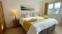 The main bedroom has an en suite and glorious views of the beach.