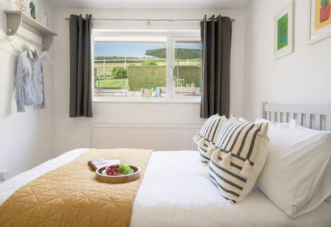 The bedroom to the back of the house has views of the garden and across the fields.