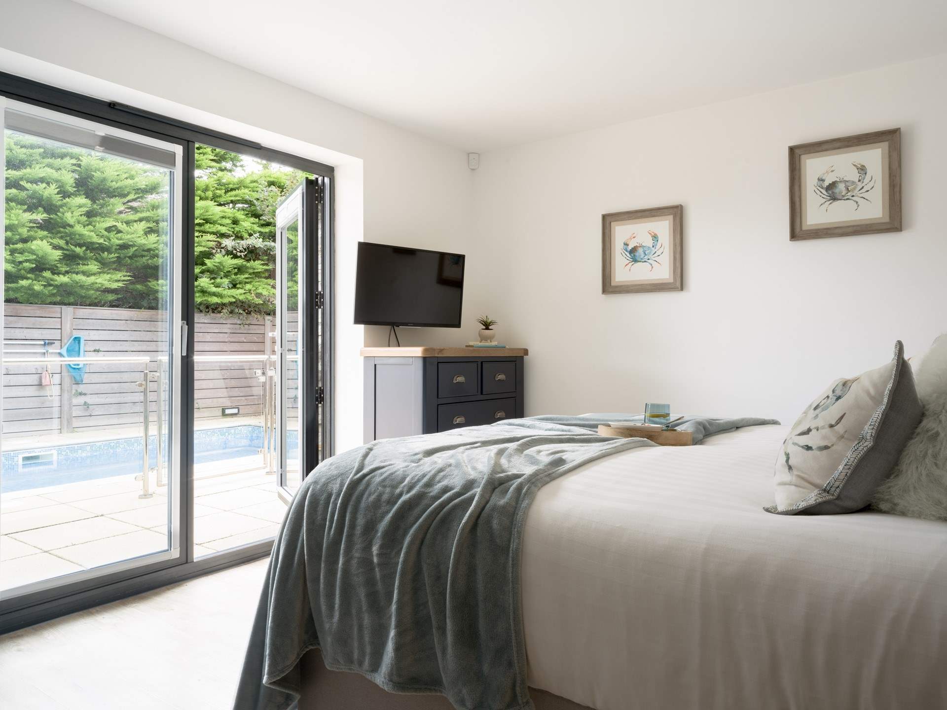 This beautiful bedroom has direct access out to the pool - perfect for a morning swim.