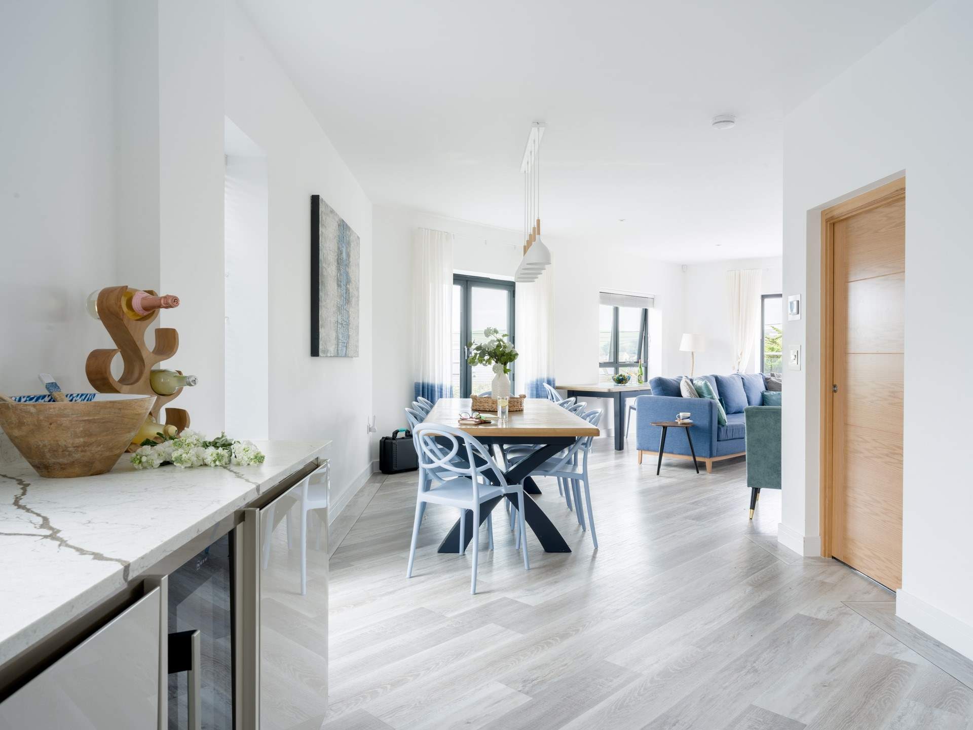 Head past the table and on to the Kitchen and utility area.