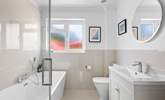 The family bathroom has a bath for a long soak after a busy beach day.  - Thumbnail Image