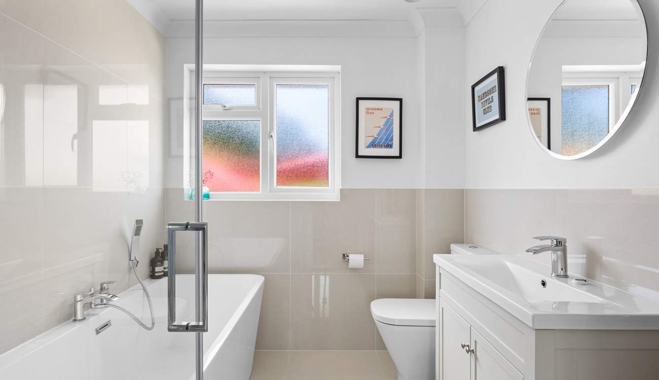 The family bathroom has a bath for a long soak after a busy beach day. 