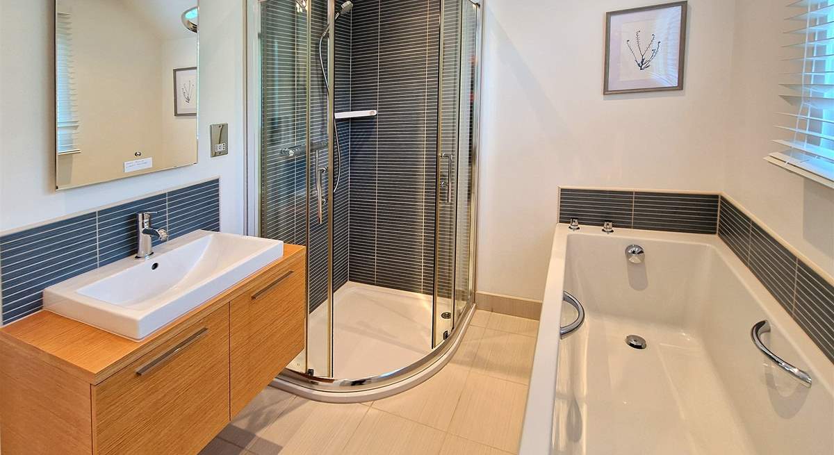 The family bathroom has a bath and shower cubicle.
