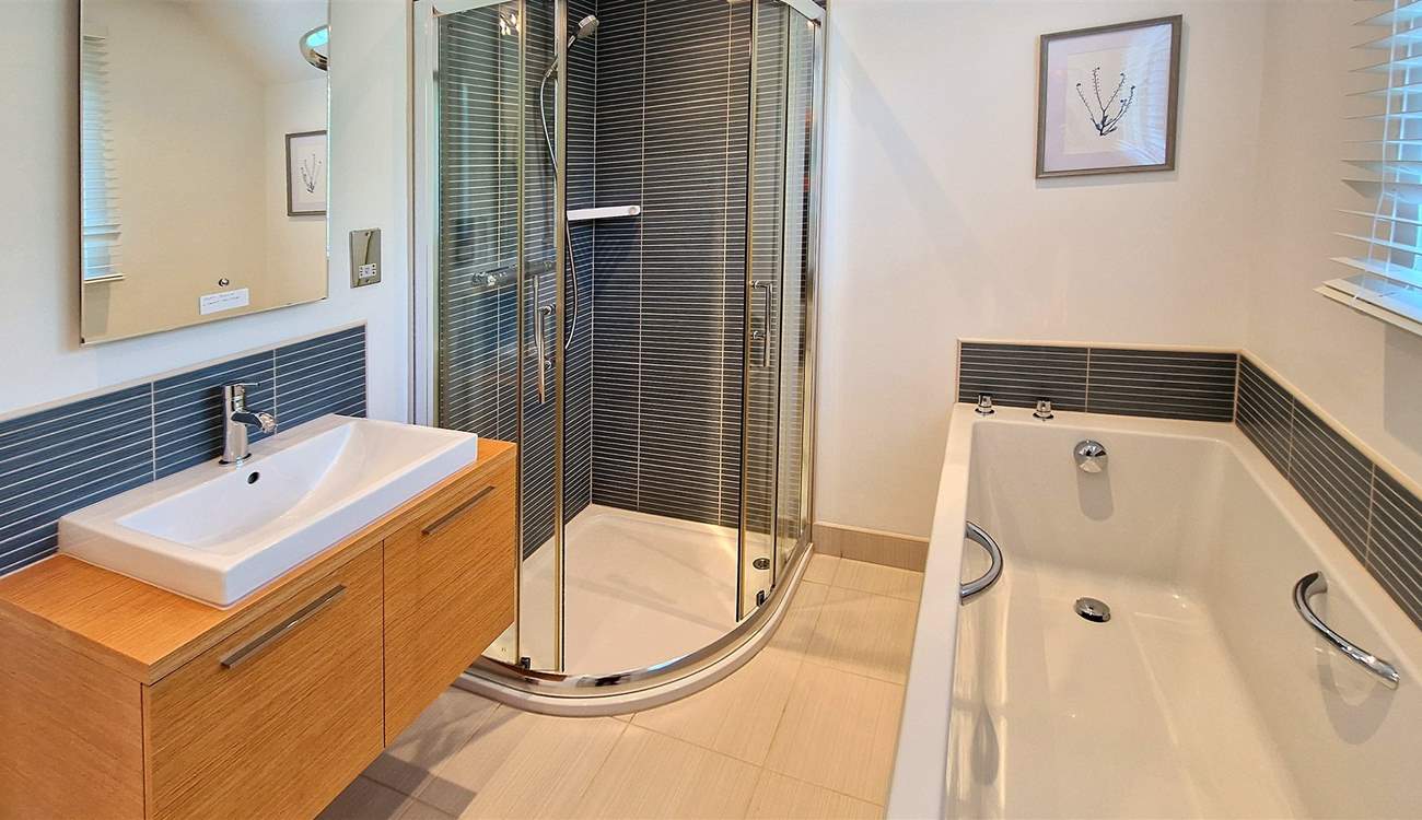 The family bathroom has a bath and shower cubicle.
