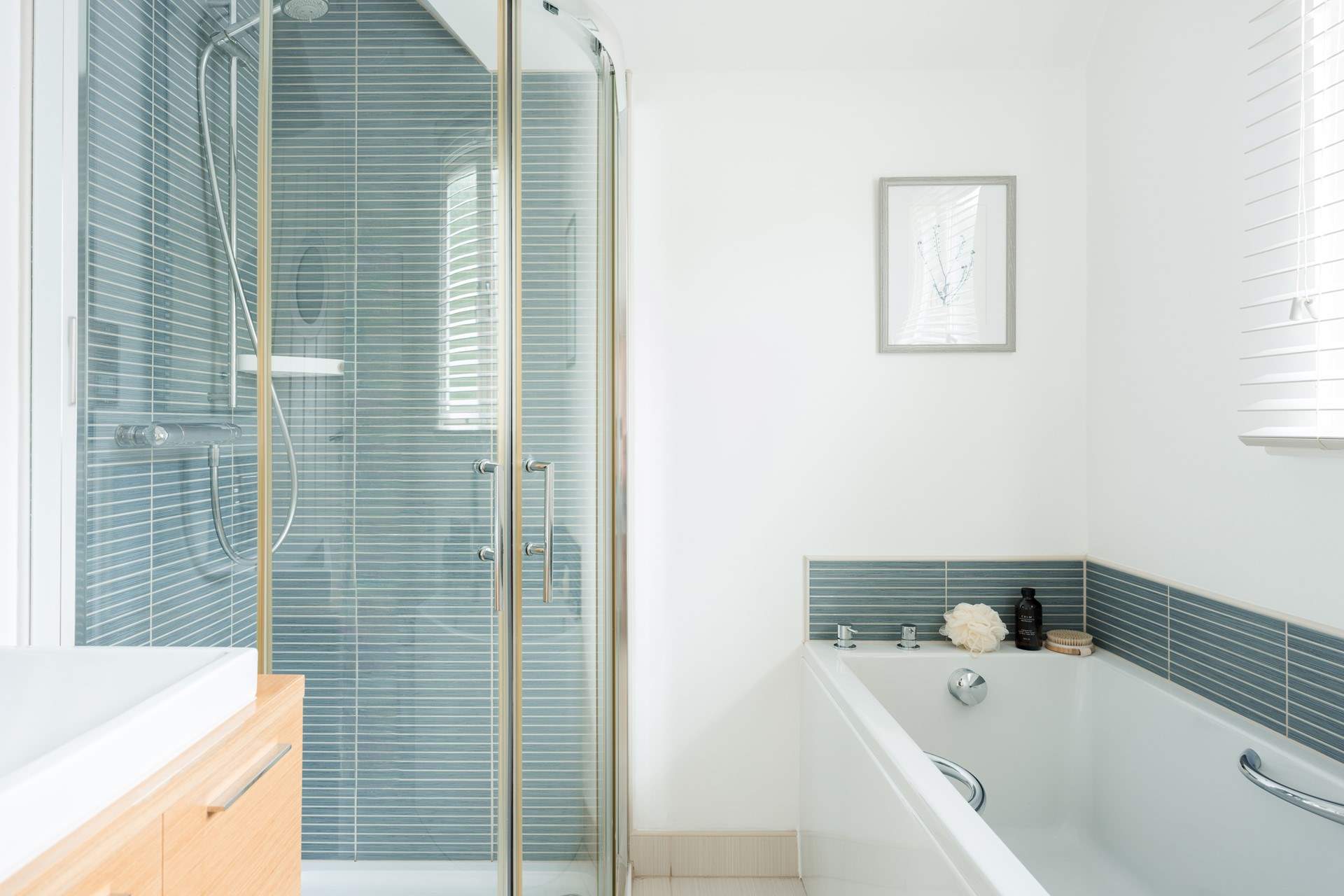 The family bathroom has a bath and shower cubicle.