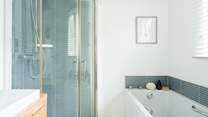 The family bathroom has a bath and shower cubicle.