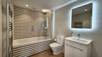 Enjoy a leisurely soak after a busy beach day in the ground floor bathroom.