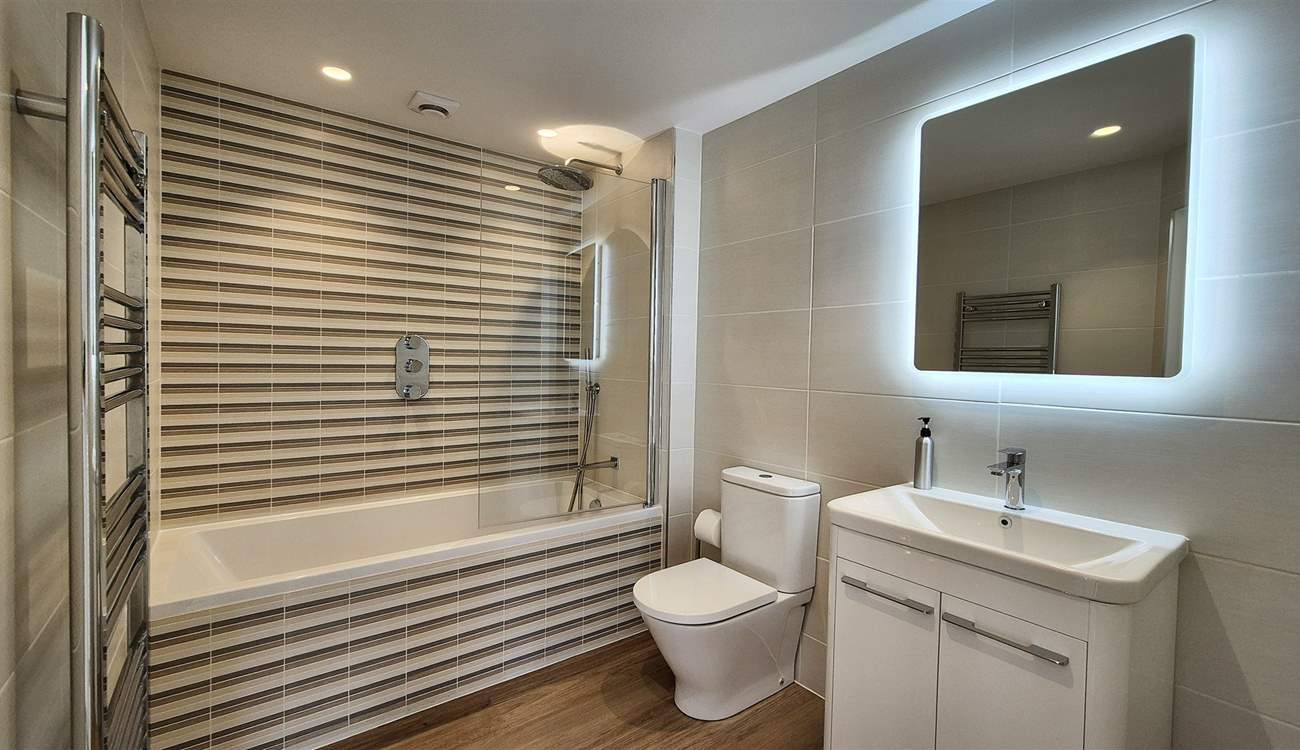 Enjoy a leisurely soak after a busy beach day in the ground floor bathroom.
