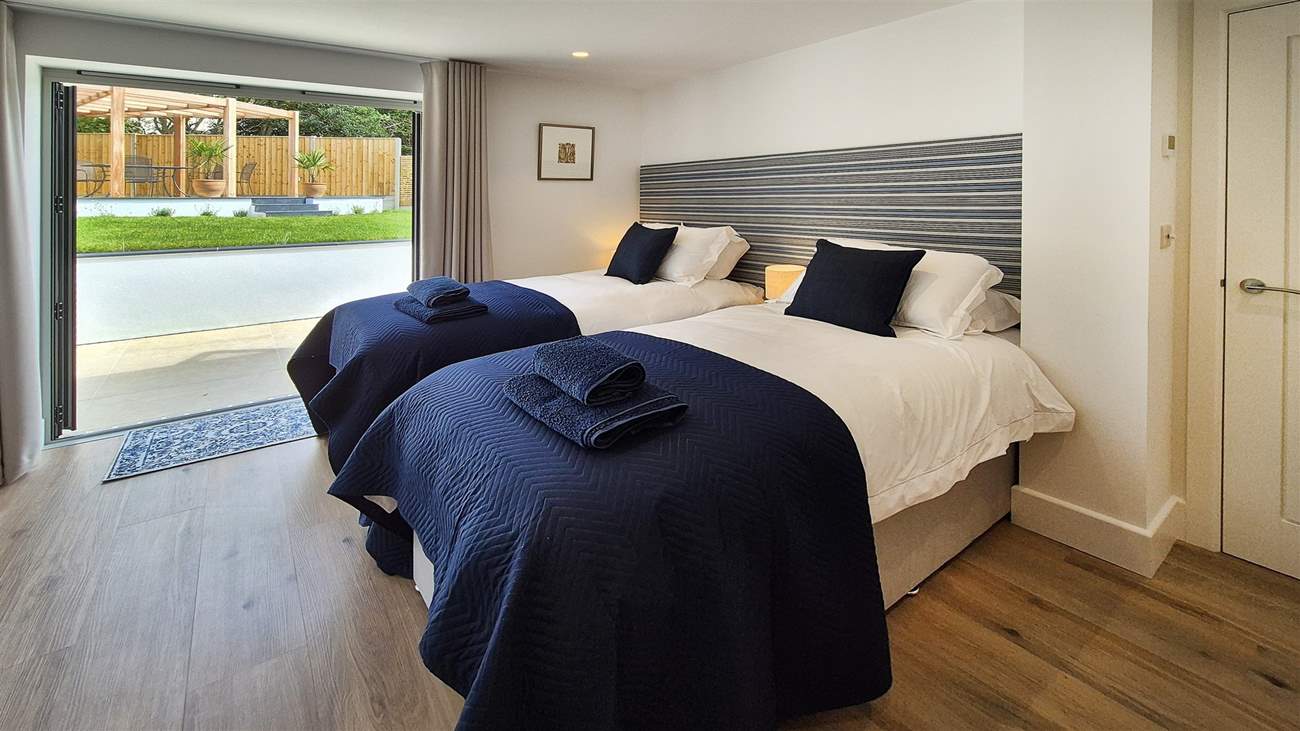 Bedroom one is a twin room with double doors leading out to the garden.