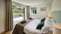 Beautiful bedroom 2 has double doors leading out to the garden.
