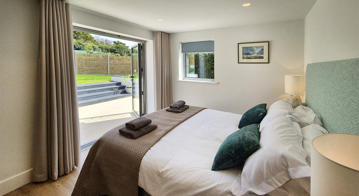 Beautiful bedroom two has double doors leading out to the garden.
