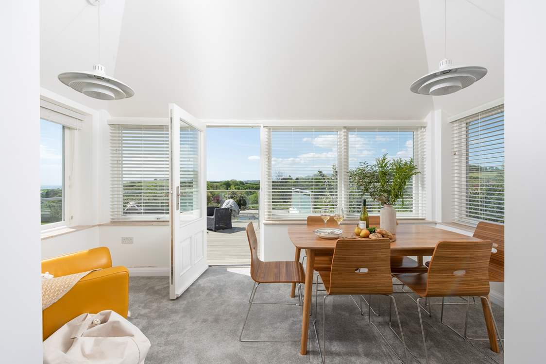 The open plan modern dining-area leading to the terrace.