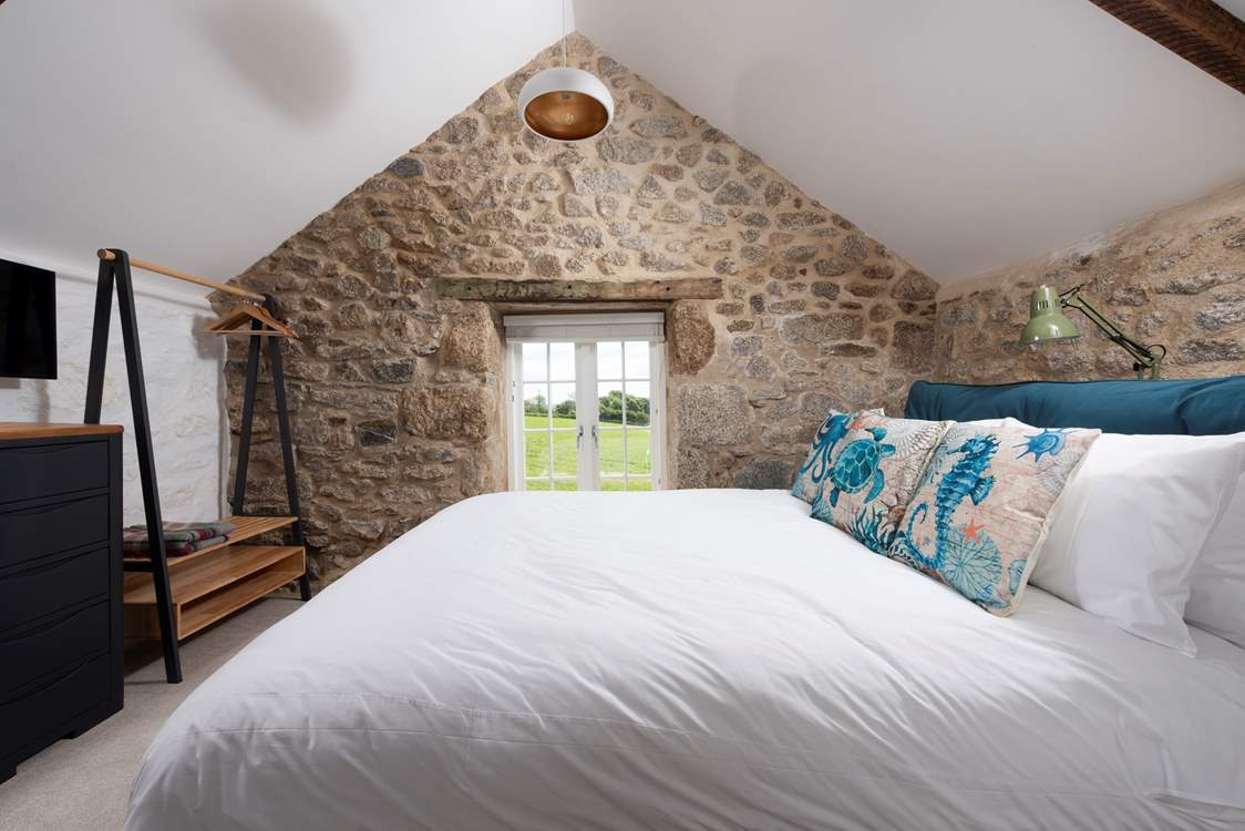 Beautiful exposed stone and wooden beams create a romantic charm upstairs in bedroom 2.