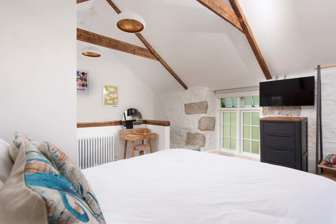 A spacious bedroom with a Smart TV.