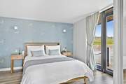 Bedroom 1 is decorated in muted tones making for a restful sleep.